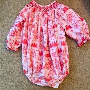 This is a Magnolia Steel Christmas Romper. It is pink and Red. Size 12 months